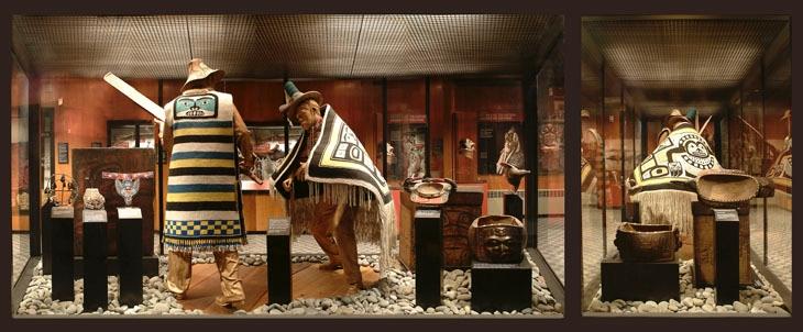 Museum display with two mannequins in traditional clothing and cultural artifacts.