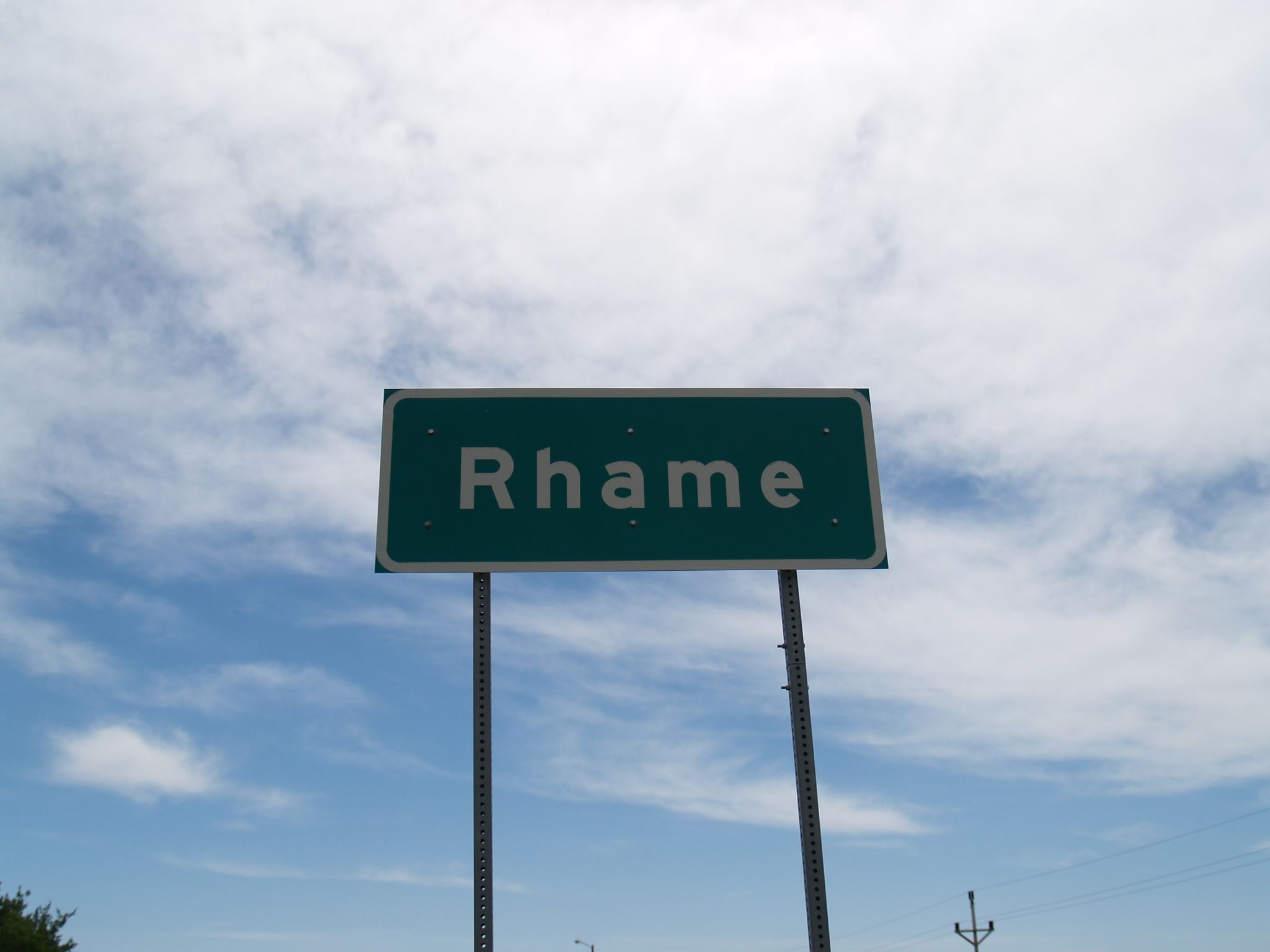A green rectangular sign on two posts against a bright, cloudy sky. - United States Bicycle Route 30 (North Dakota)
