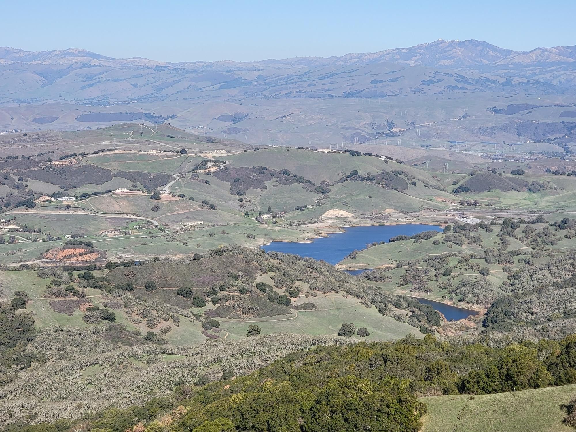 Panoramic view of rolling green hills, distant mountains, and two blue lakes. - Bald Peaks and Longwall Canyon Loop