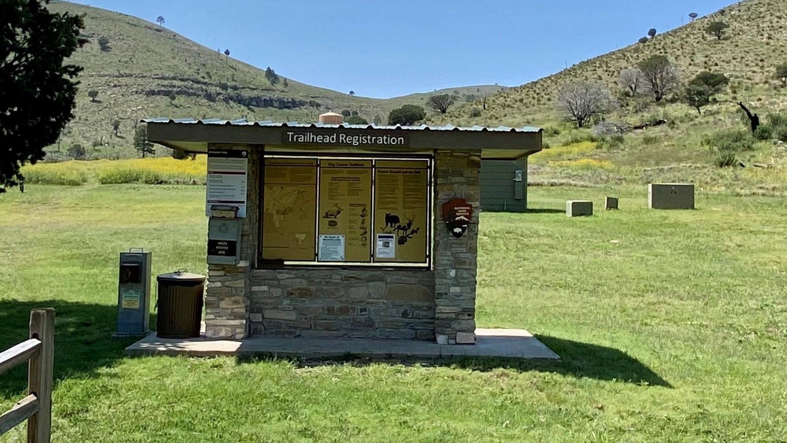 Trailhead registration kiosk in a sunny, grassy field with rolling hills. - Lost Peak via Tejas and Bush Mountain Loop