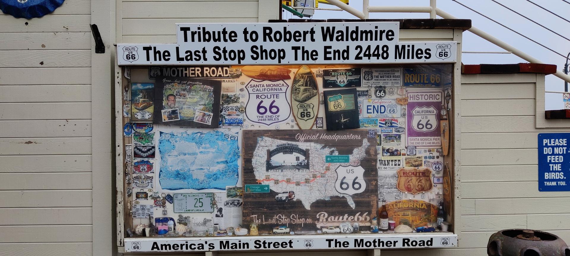 A display board with maps, signs, and text about a historic route.