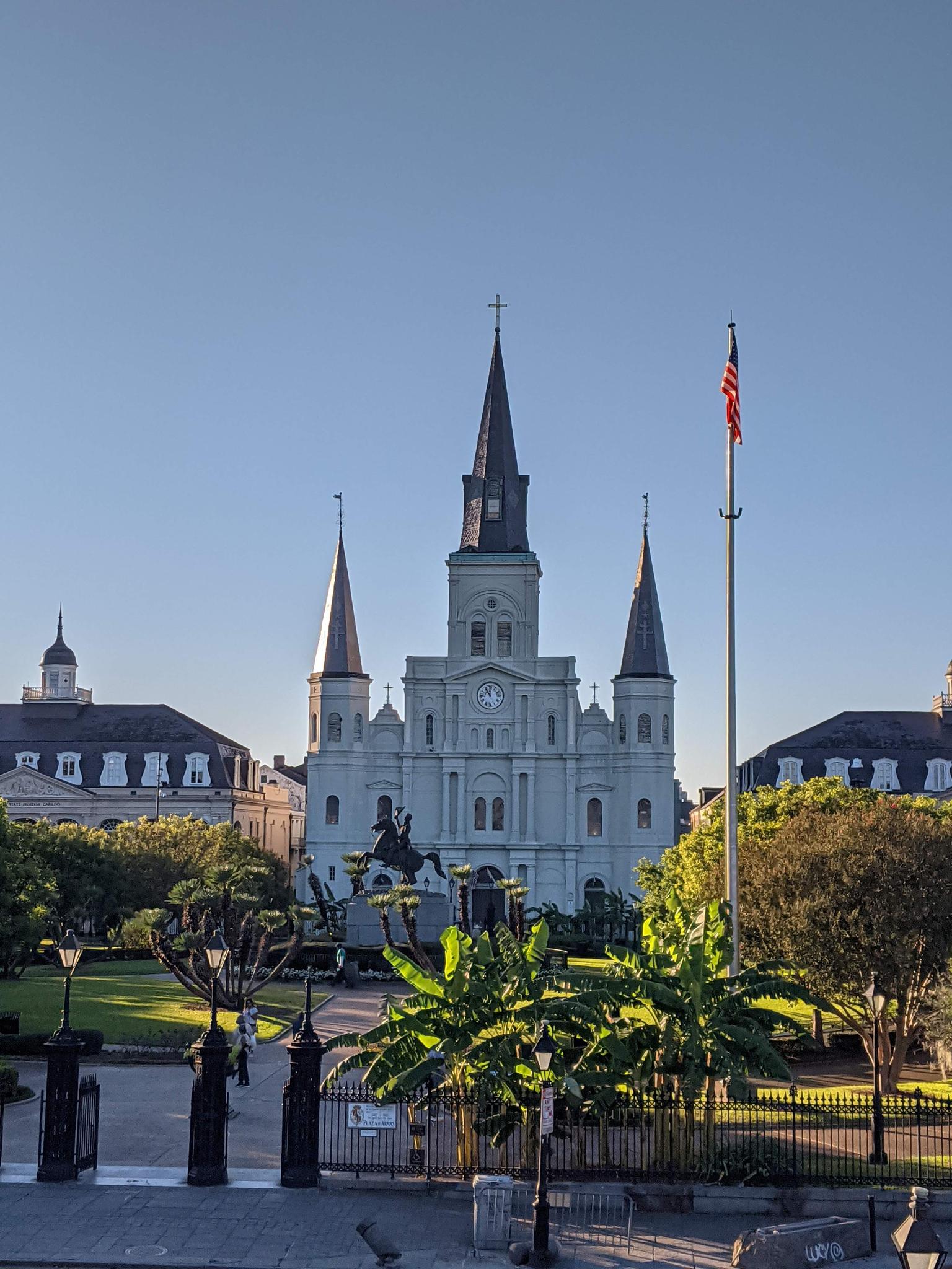 A grand cathedral with spires stands majestically against a clear blue sky.