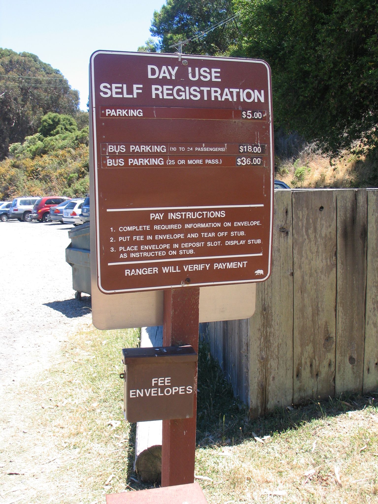 Brown 'Day Use Self Registration' sign with parking instructions in daylight. - Back Ranch Meadows Loop