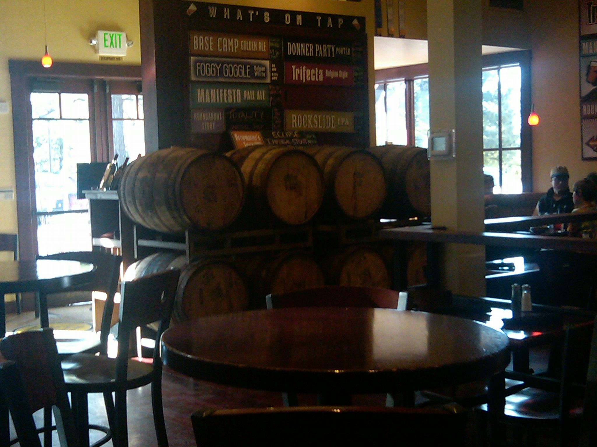 Interior of a pub with wooden barrels, tables, and people in the background. - Brockway Road – Fiftyfifty Brewing Co. loop from Union Mills