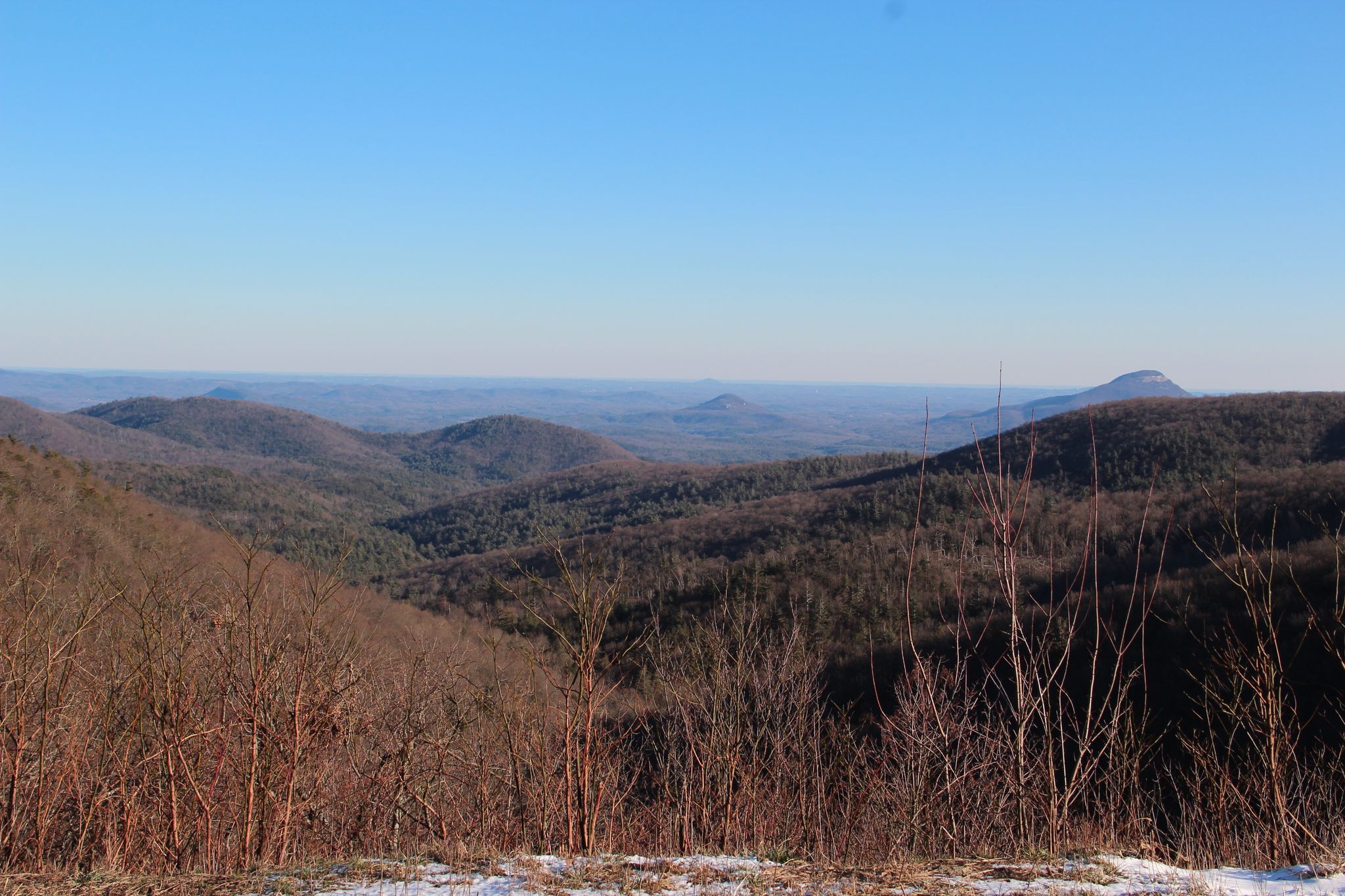 Vast mountain landscape with bare winter trees, distant hazy peaks, and clear sky. - Helen to Steedly Mountain via Richard B. Russell Scenic Highway loop