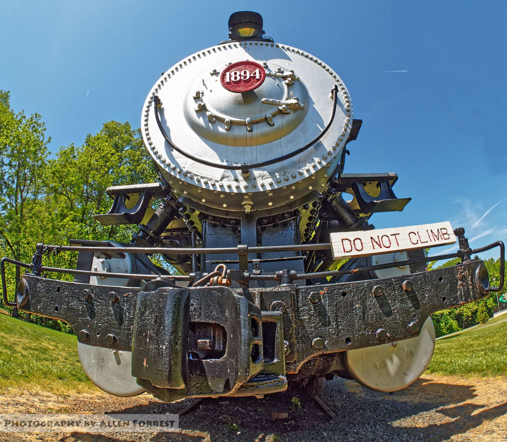 Front view of a historic steam locomotive under a bright blue sky. - Mountains to Sea Trail: Tanglewood Park Loop