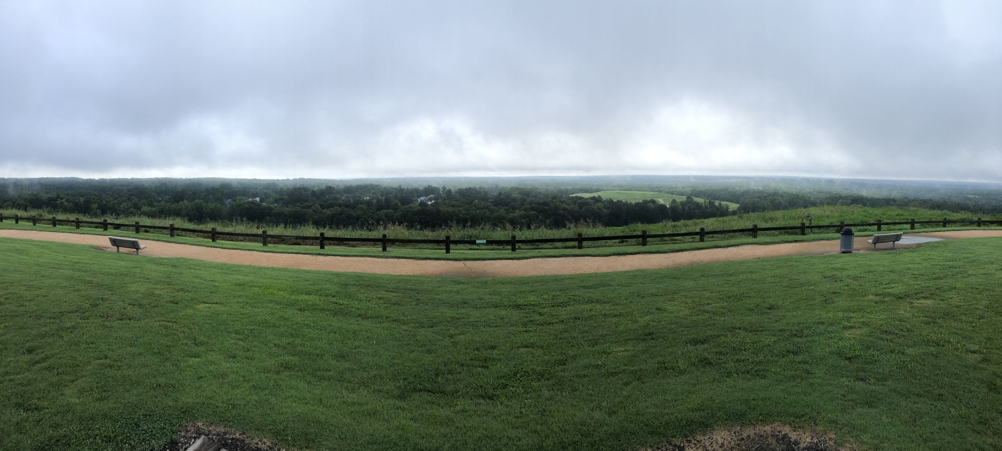 Overcast panoramic view of green hills, a path, fence, and distant forest. - Abbotts Creek Trail to Green Hill loop