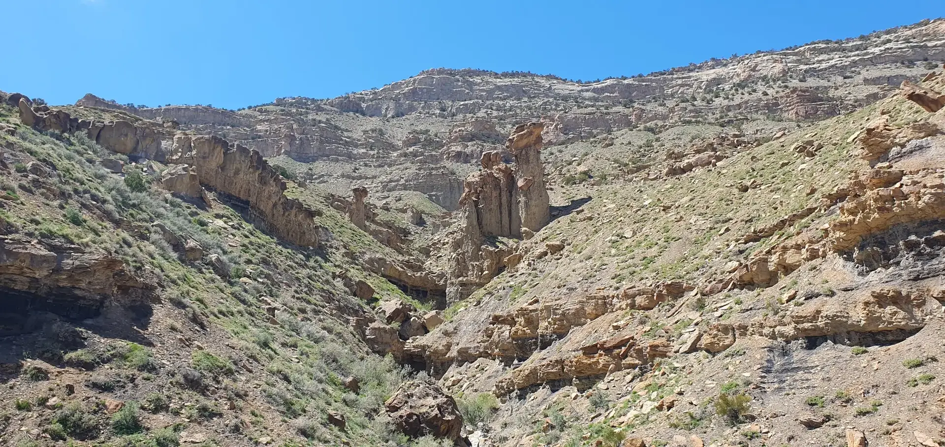 Bright sunny view of a deep rocky canyon with unique formations.