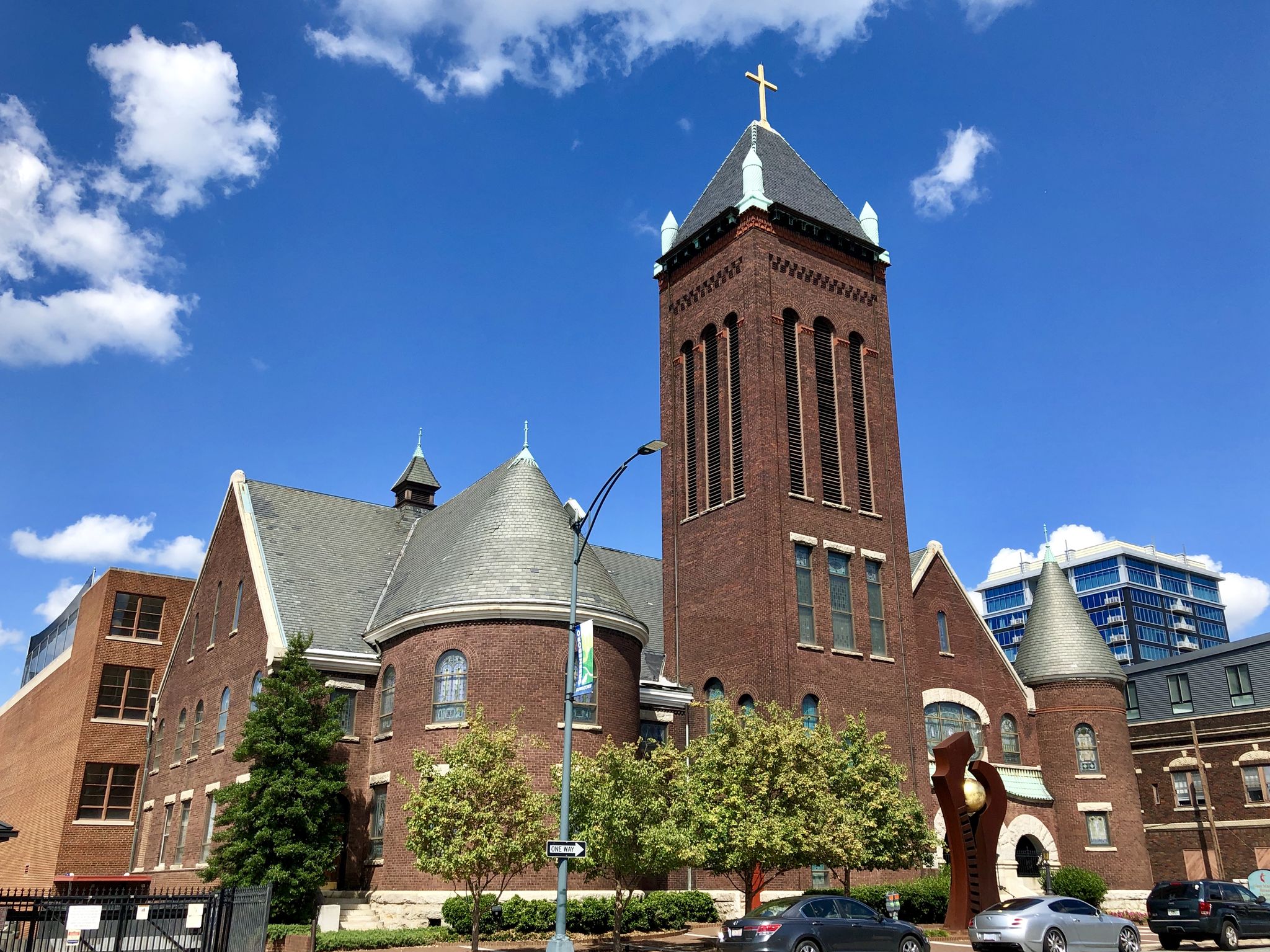 Large brick church with a tall steeple under a bright blue sky. - Greensboro to Lake Townsend loop