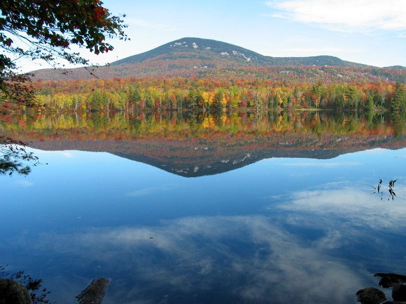 Vibrant autumn trees and a mountain reflect perfectly in a calm lake. - Cascade Pond and Northville-Placid Trail Loop