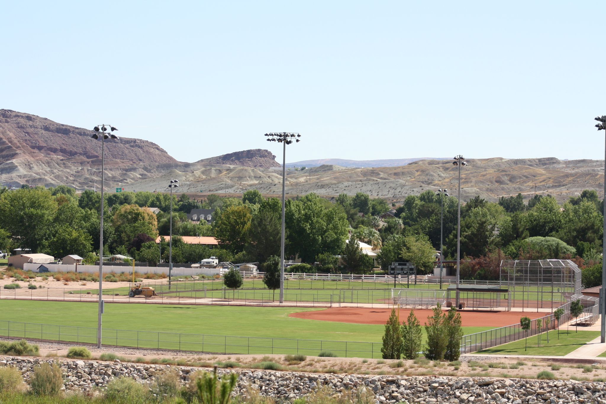 A bright daylight view of an empty baseball field with distant hills. - Bloomington Park – Red Mountain loop from Webb Hill