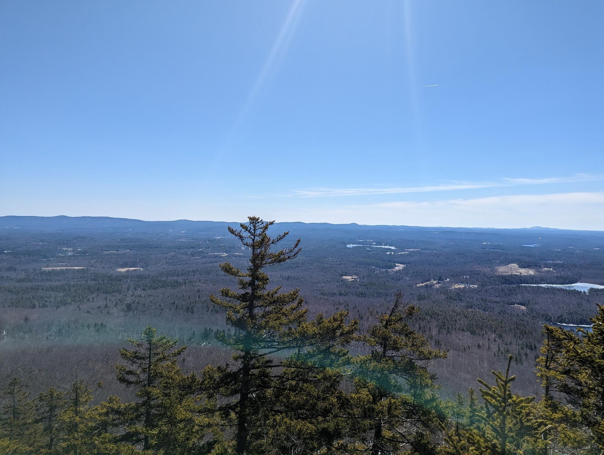 Sunny panoramic view of vast forests and distant hills under a clear sky. - Parker and Lost Farm Trail Loop