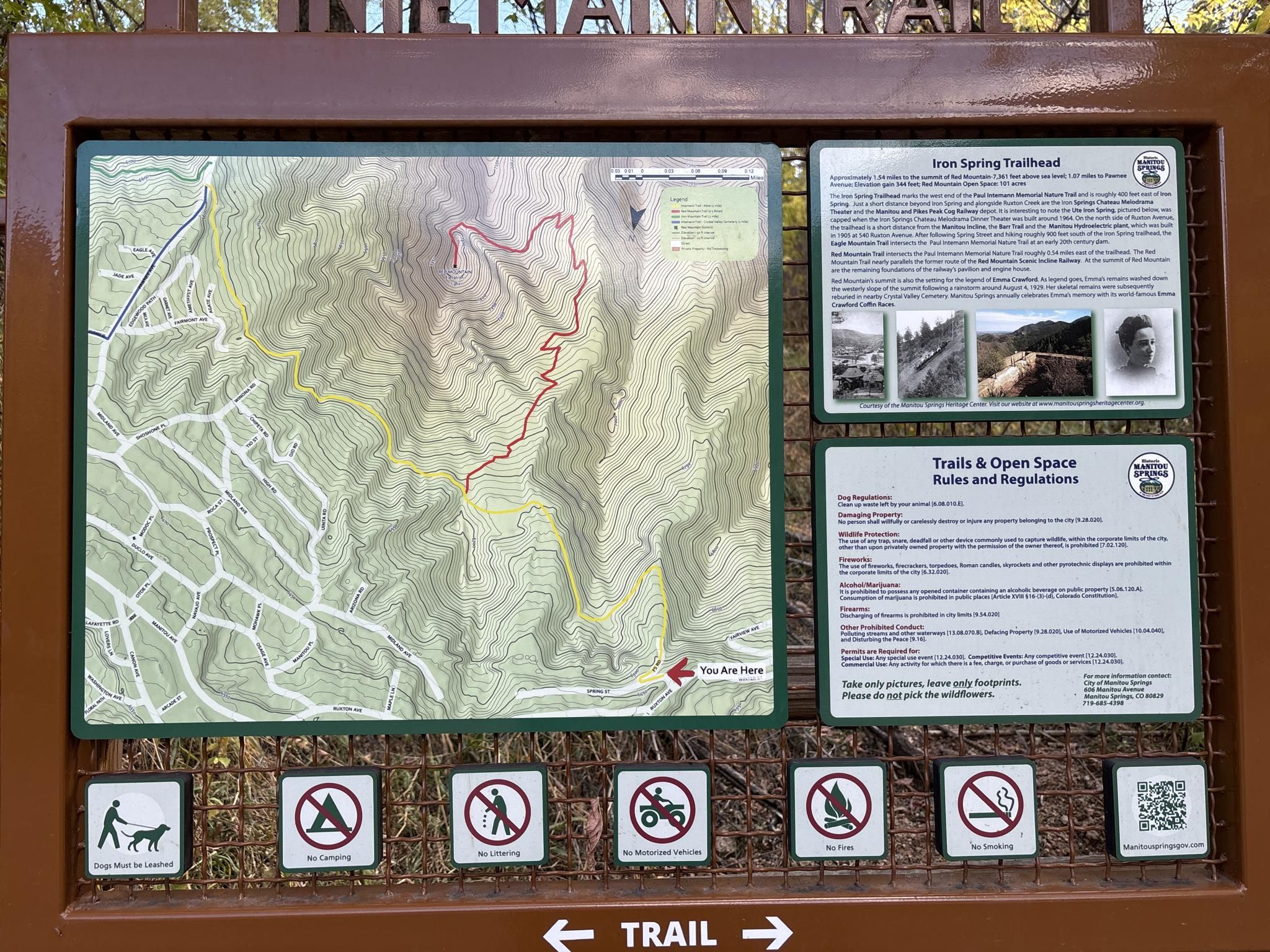 An outdoor information board displays a trail map, rules, and regulations. - Paul Intemann Nature Trail