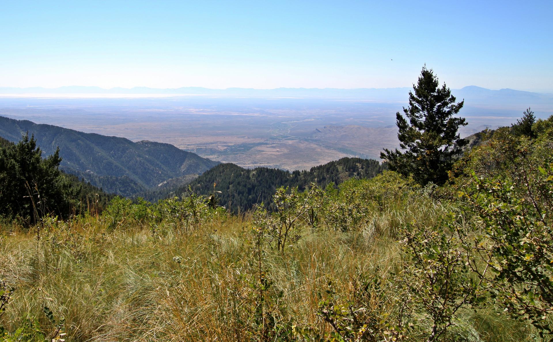 Expansive mountain view overlooking a vast valley on a clear day.