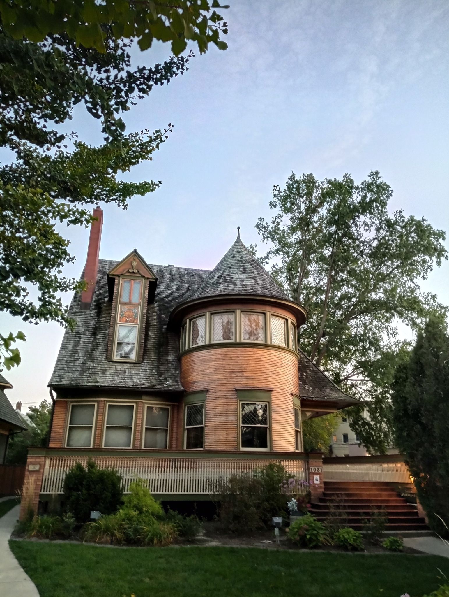 An ornate house with a round turret and porch under a clear sky. - The Walter Gale House loop from Austin