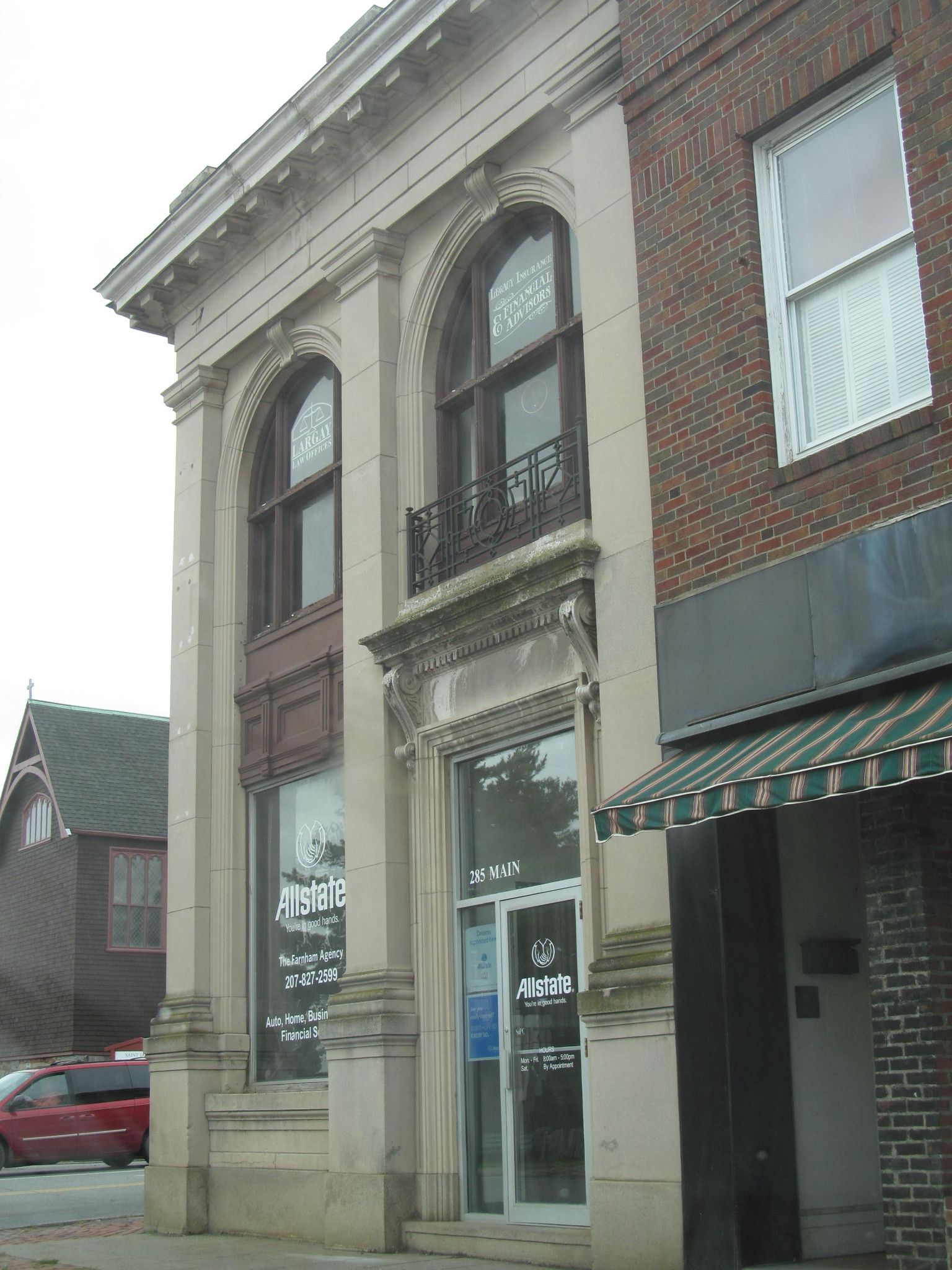 Old stone and brick building with arched windows on an overcast day. - Orono and Old Town loop