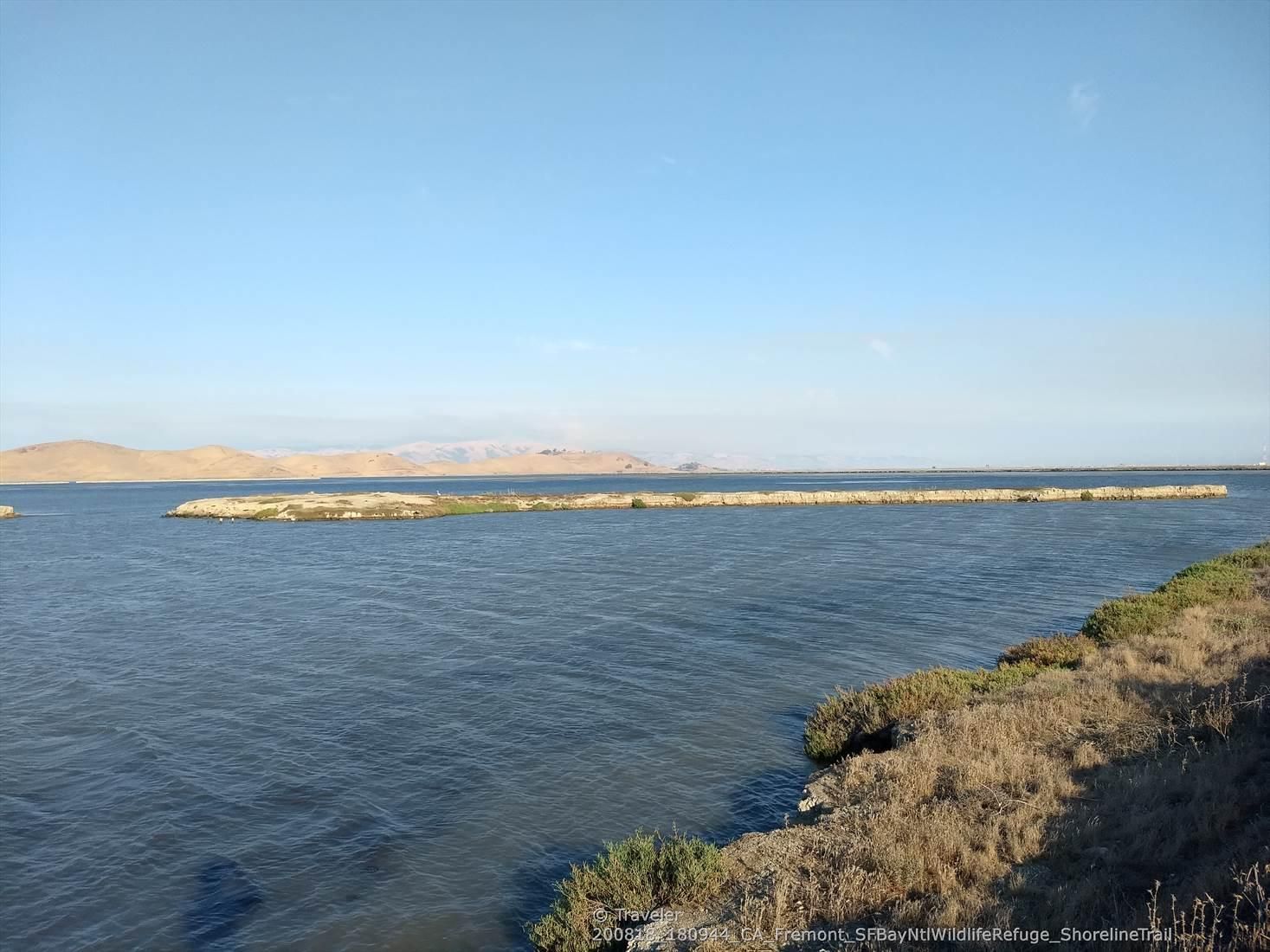 Wide expanse of water with a narrow land strip and distant hills. - San Francisco Bay Trail: Coyote Hills