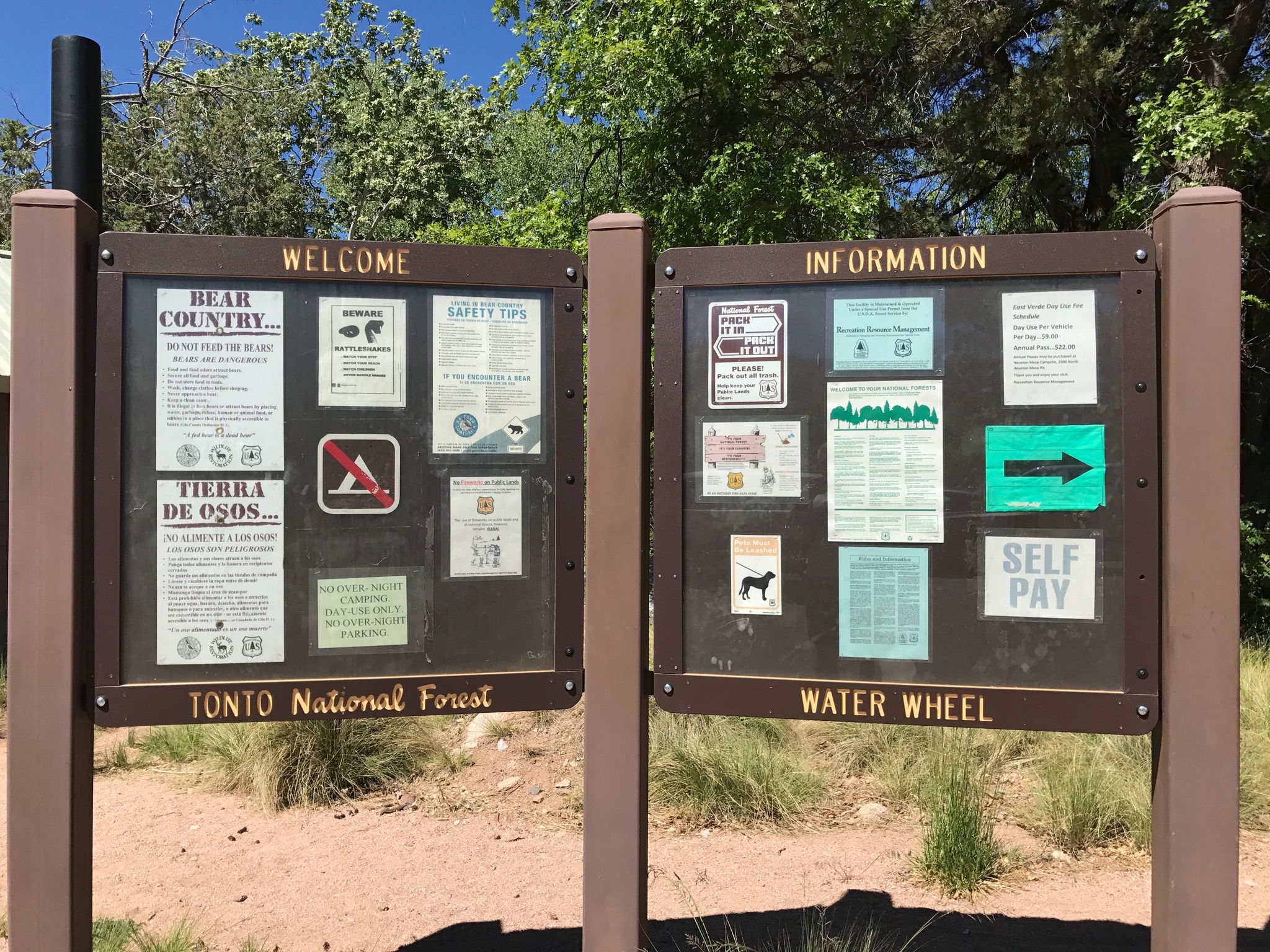 Two brown information boards stand outdoors under bright sunlight. - Water Wheel Falls Trail
