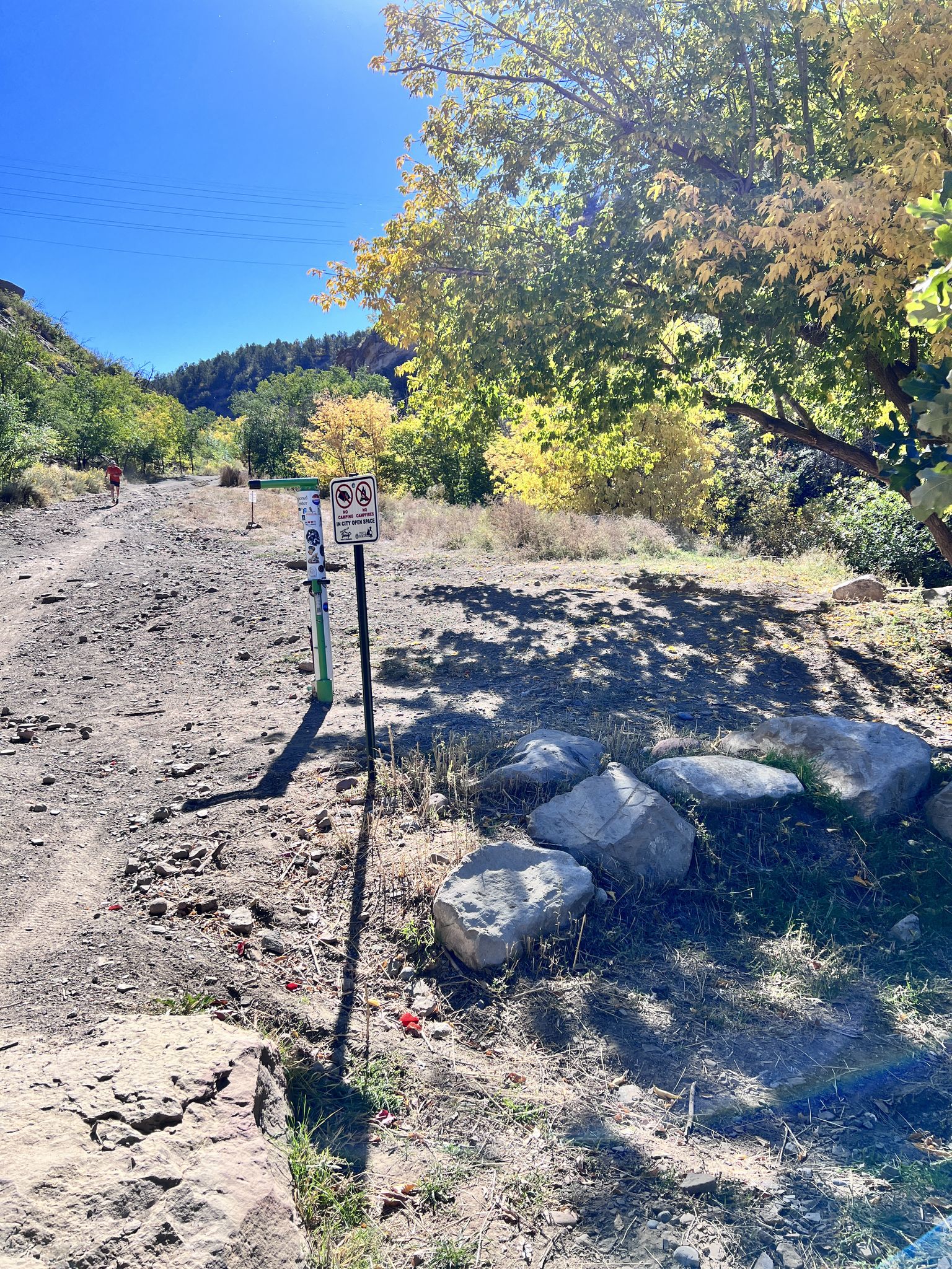 Dirt path with signs and large rocks under bright, leafy trees. - Horse Gulch Trailhead – Horse Gulch Road loop from Durango & Silverton Narrow Gauge Railroad