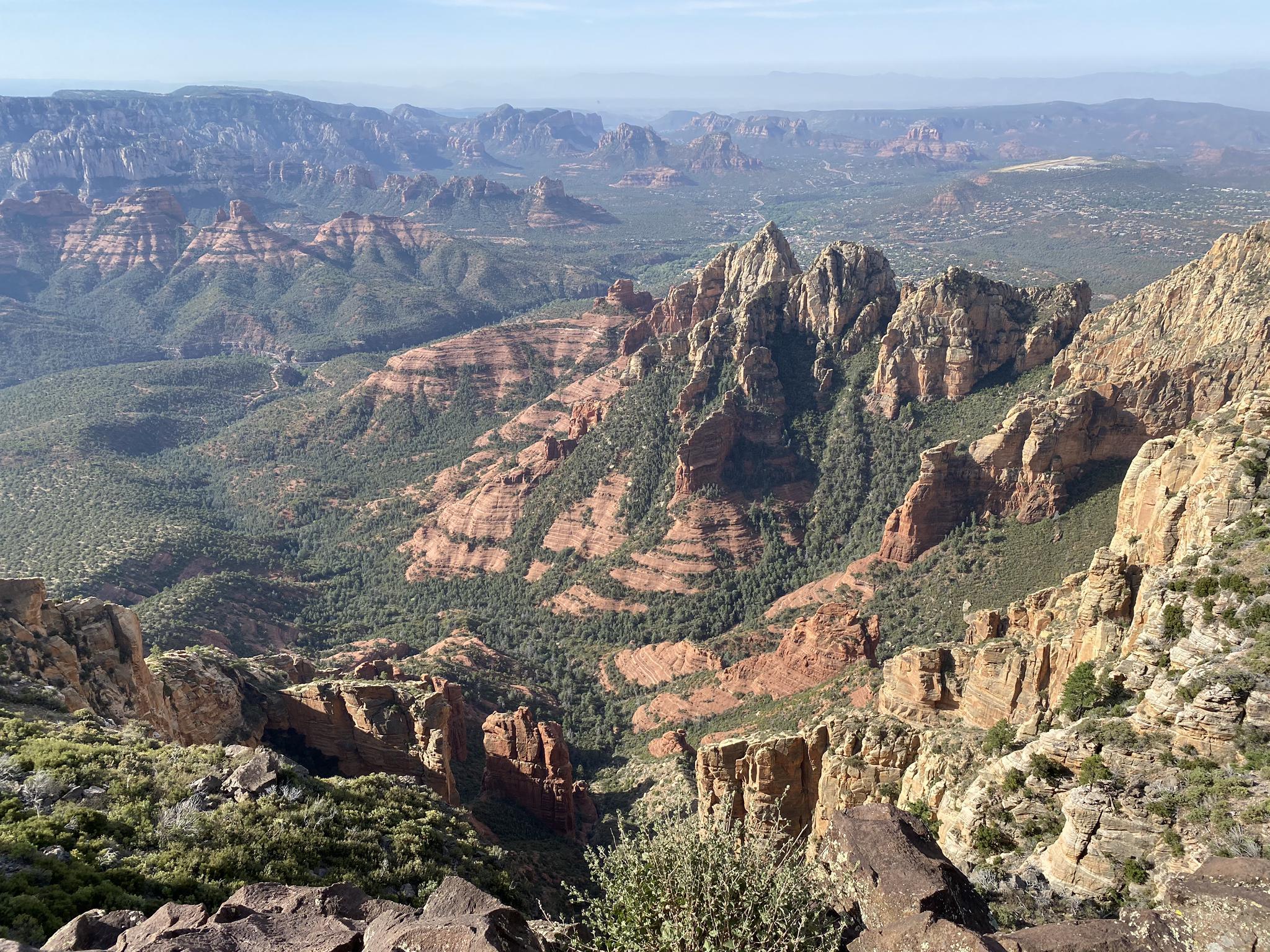 Panoramic view of vast, rugged mountains and canyons under a clear sky.