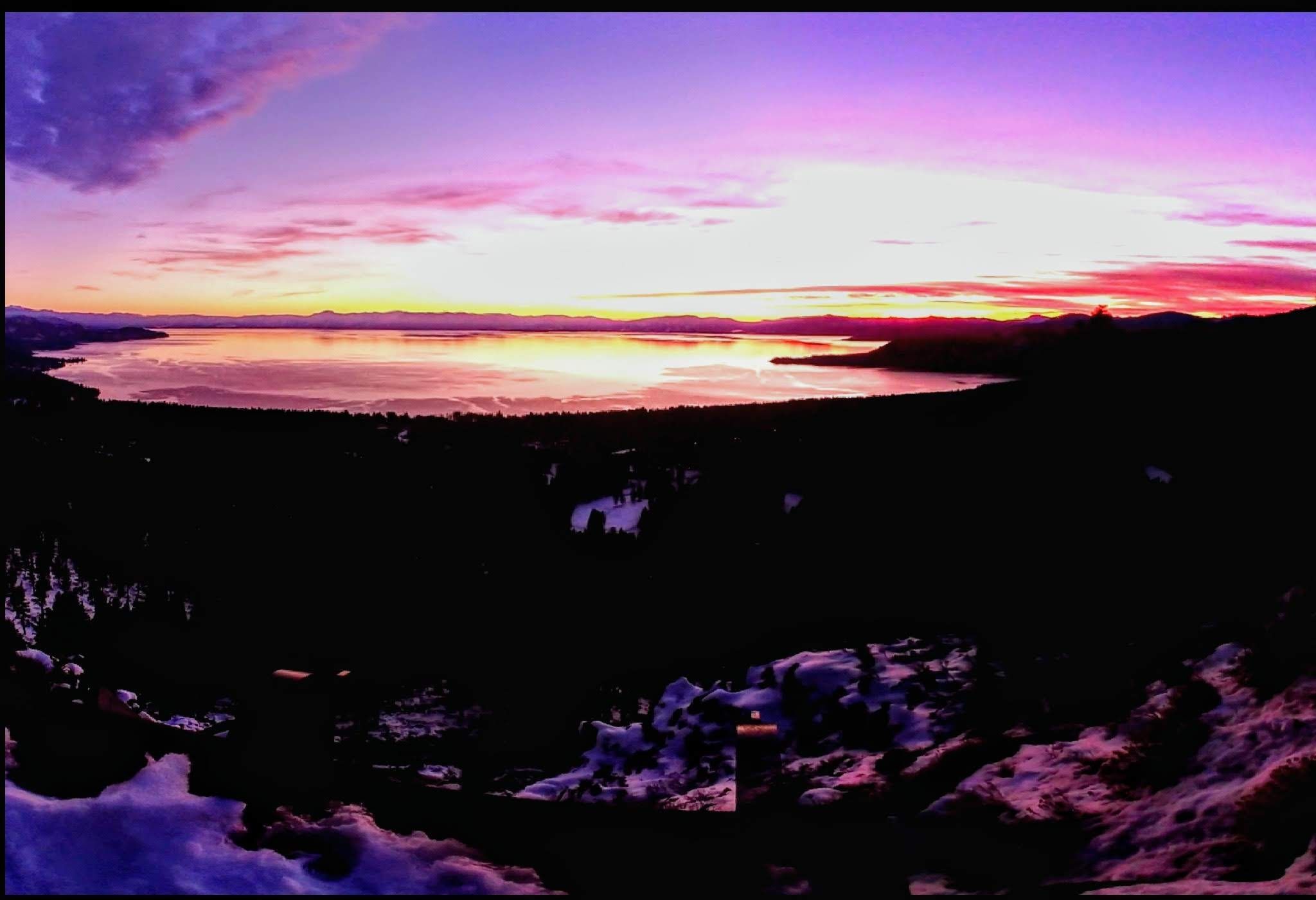 Panoramic view of a lake at sunset with vibrant pink and purple sky. - Incline Village to Mt Rose Summit loop
