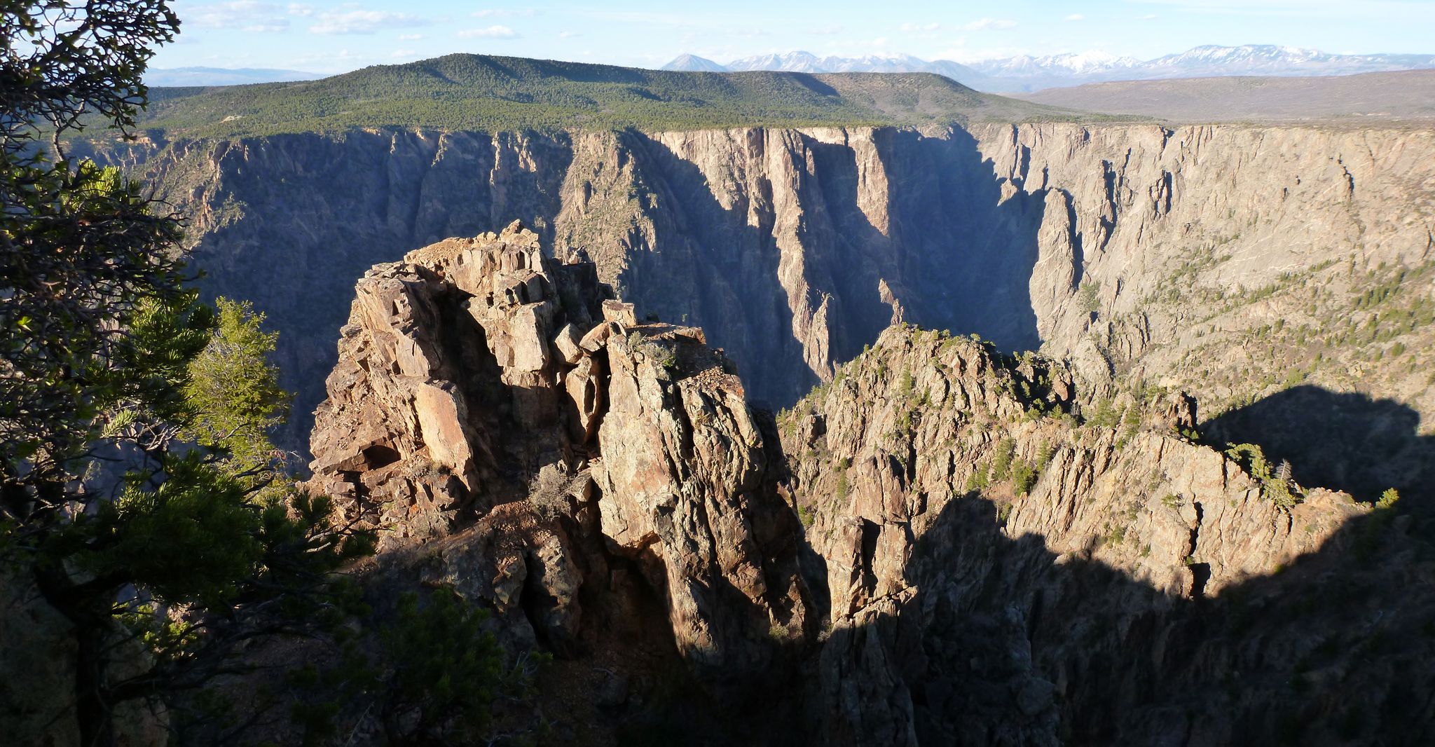 Dramatic canyon with sunlit rock formations and deep shadows under a clear sky. - Warner Route