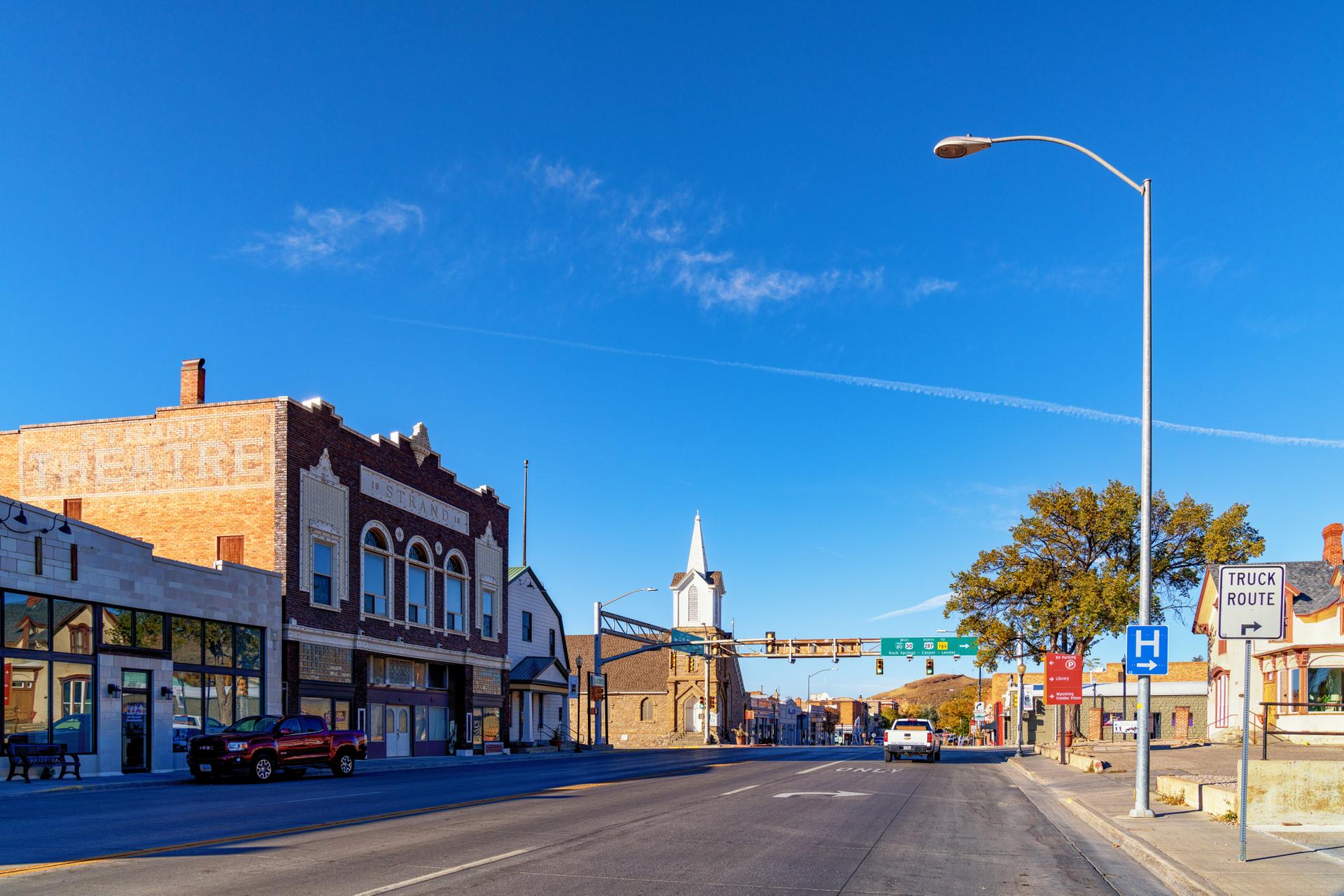 Bright sunny day on a quiet street with historic brick buildings.