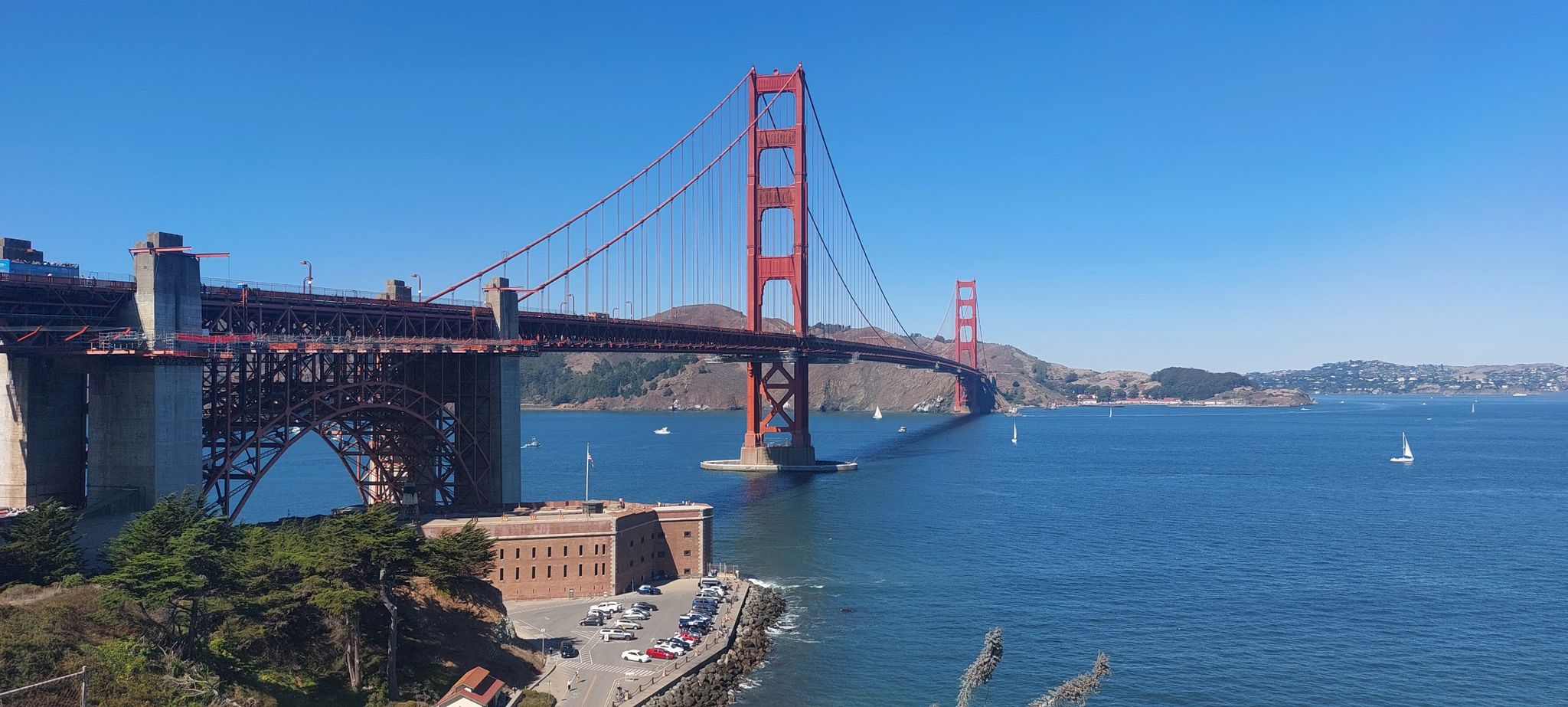 Red suspension bridge over blue water, clear sky, sunny. - California Coastal Trail: Lands End to Golden Gate Bridge