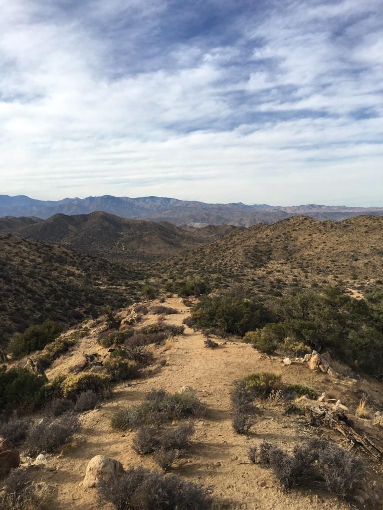 Winding dirt path on a desert ridge with rolling hills and cloudy sky. - Hiking loop from BLM - Blackrock Interagency Fire Center,