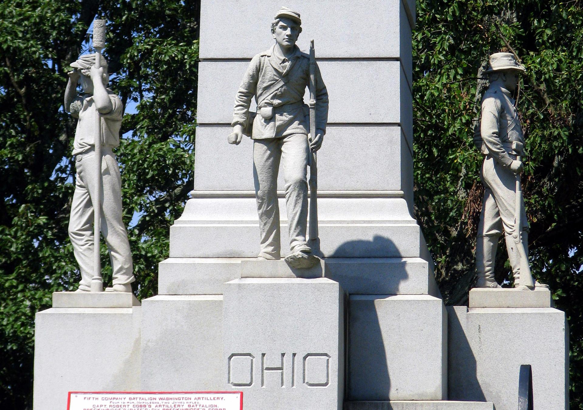 Close-up of a monument with three soldier statues and "OHIO" carved.