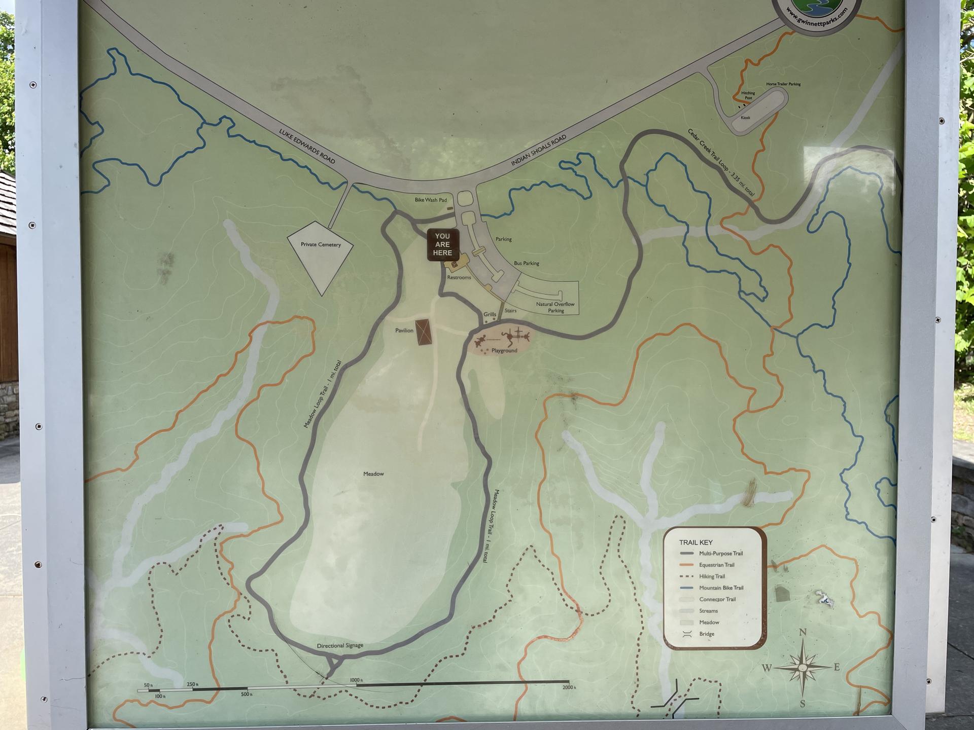 An outdoor display shows a detailed map of trails and park features.