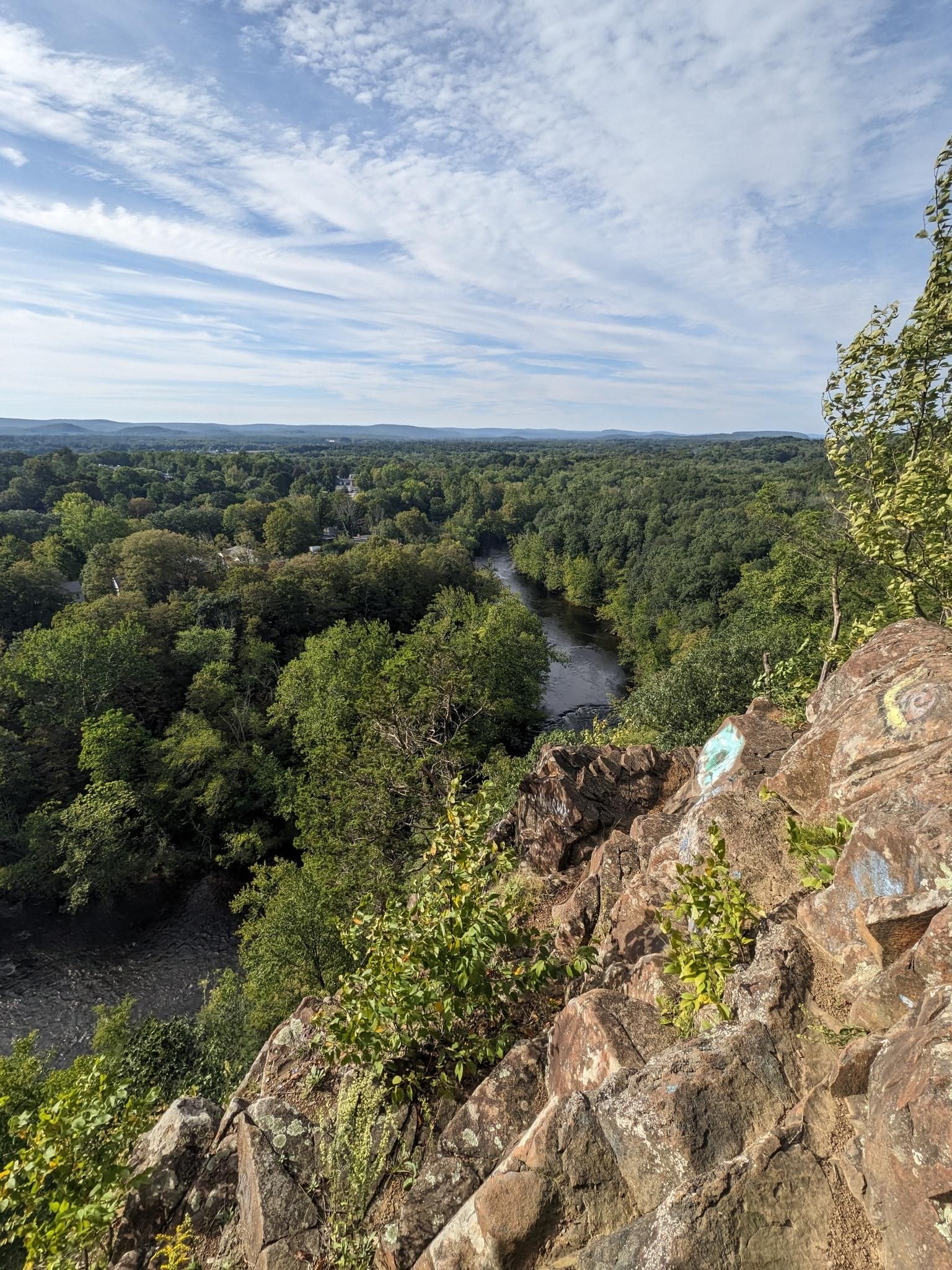 Elevated view of a winding river through dense green forest under a cloudy sky. - Hatchett Hill loop from Tariffville