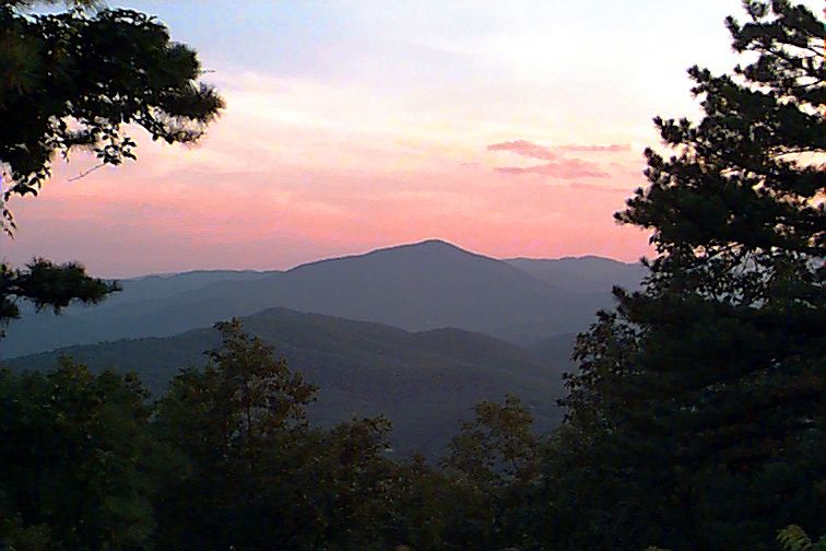 Silhouetted mountains and trees under a vibrant pink and purple sunset sky. - Smart View Recreation Area to Roanoke Mountain Loop Road