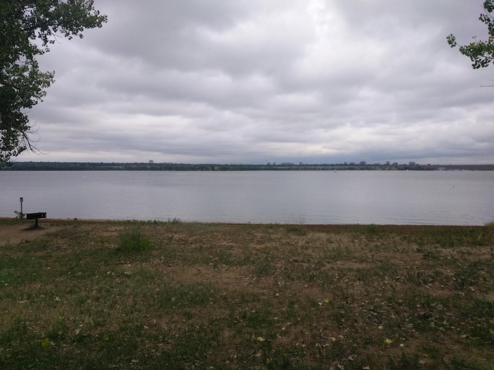A wide lake view under an overcast sky, with a distant shoreline.