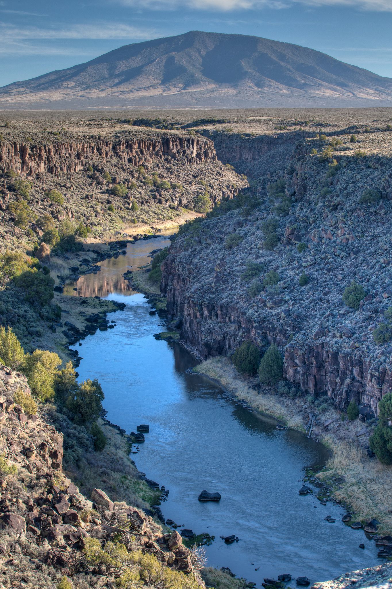 A river winds through a deep canyon, with a large mountain in the distance. - La Junta Point loop from Big Arsenic