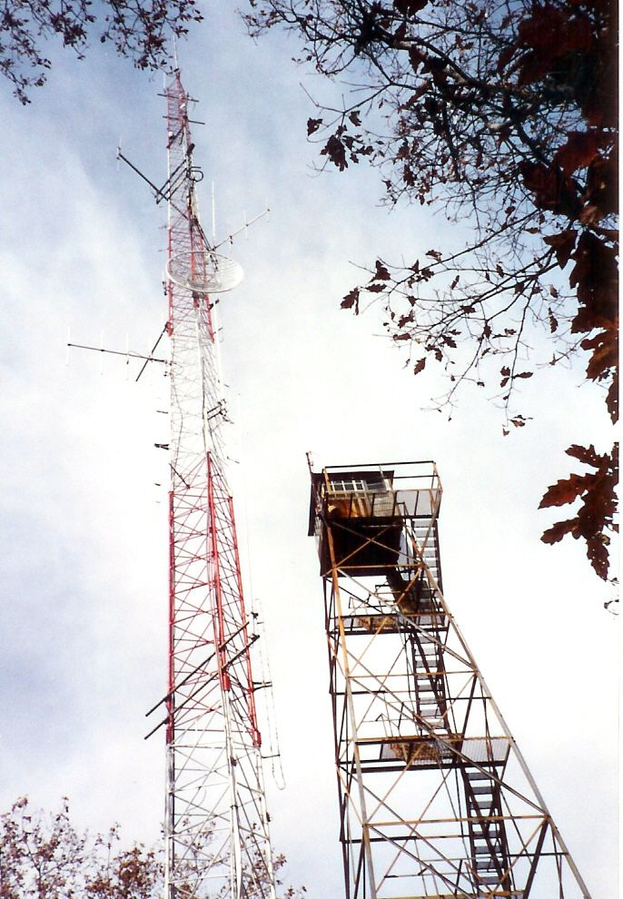 A tall red and white communication tower next to a shorter observation tower. - Laurel Highlands Hiking Trail