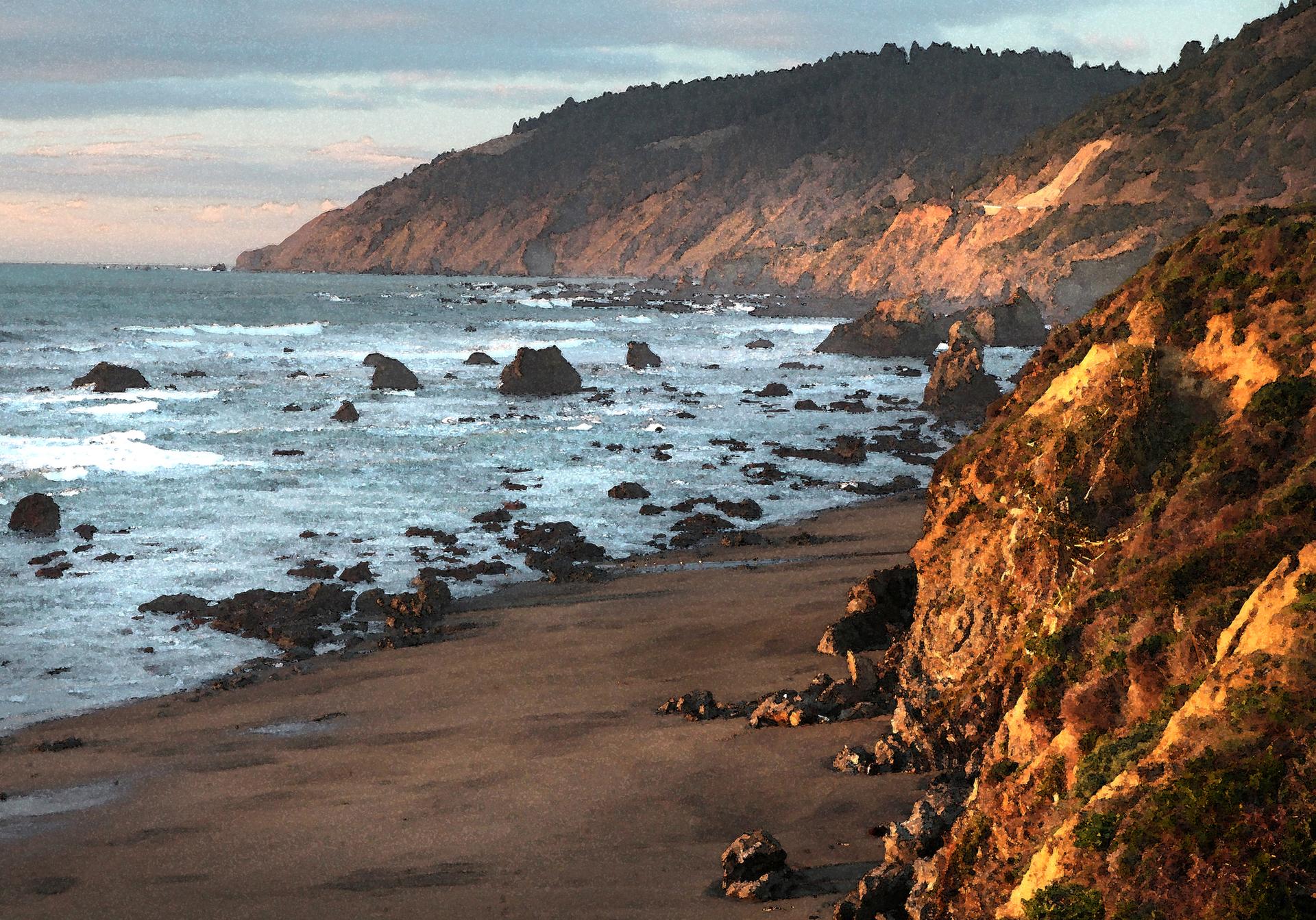 Rocky beach with ocean waves and cliffs in warm evening light.