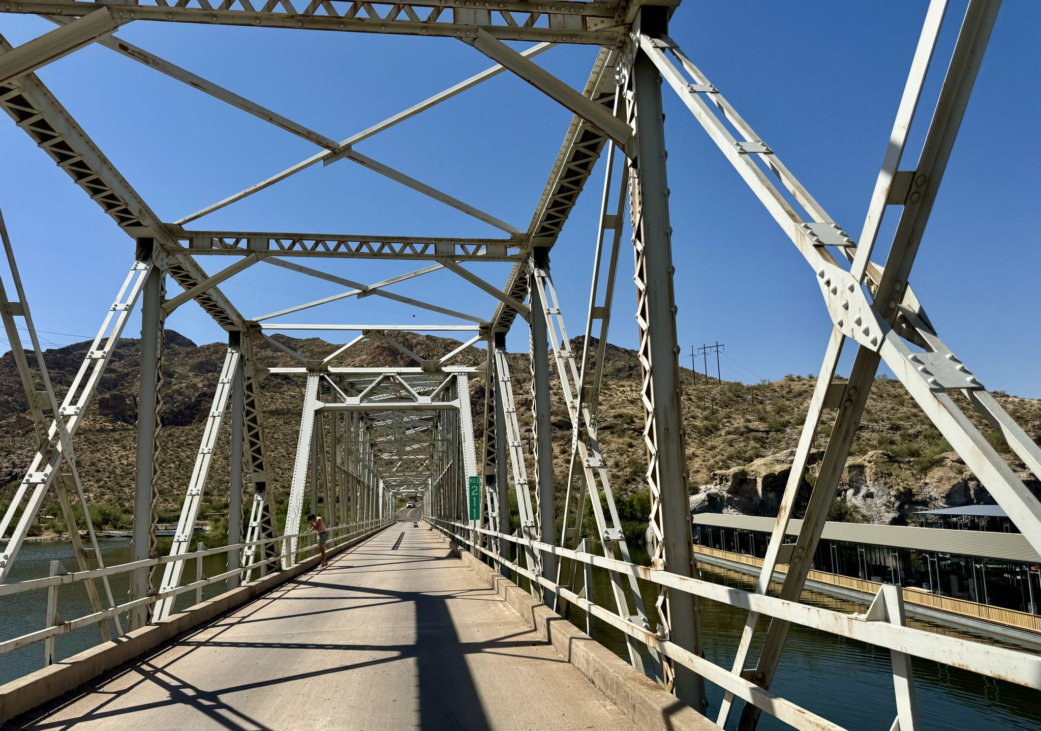 Metal truss bridge spanning over water with mountains in the background. - View of Rock Pinnacle – Boulder Creek Bridge loop from Crosscut Trail Head