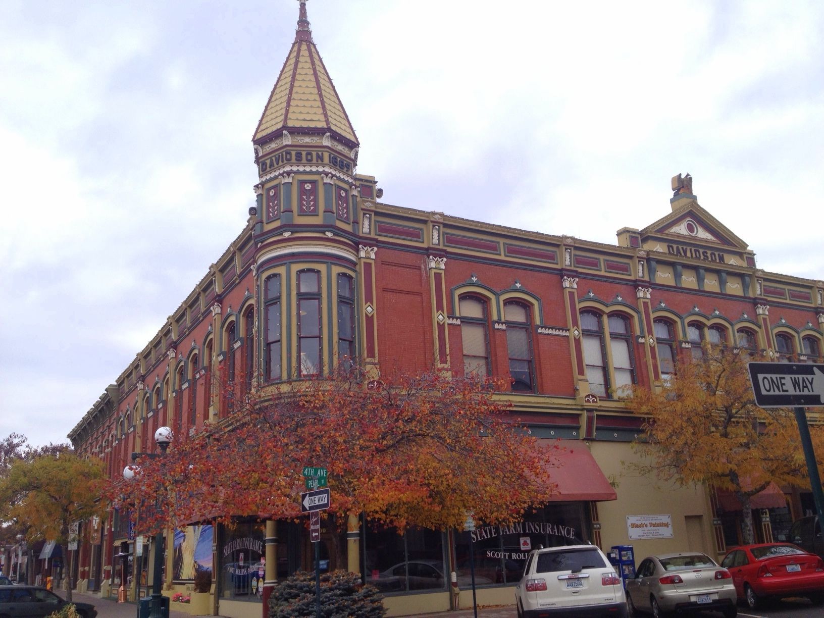 Ornate red brick building with a corner turret on an overcast day. - Palouse to Cascades State Park Trail