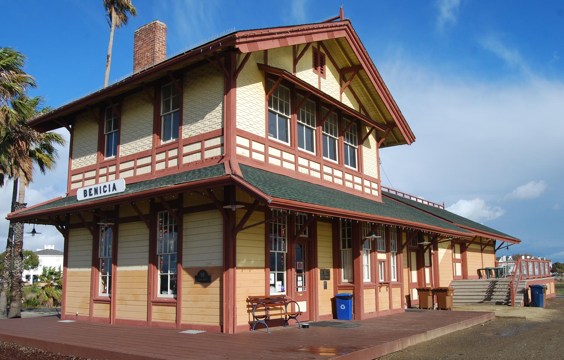 Ornate, historic-style building with a sign, 'BENICIA,' under a bright sky.