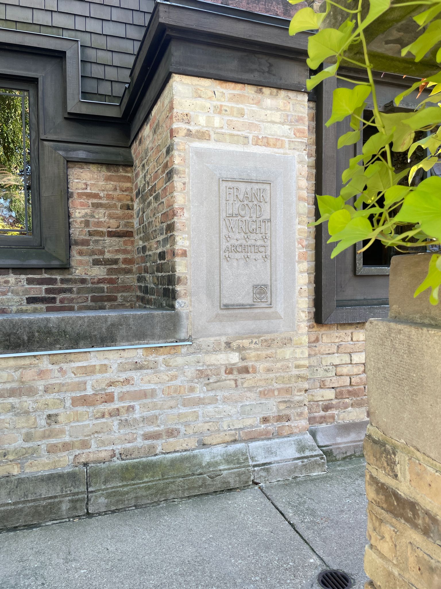 A stone plaque on a brick wall of a building in bright sunlight. - Running loop from Ridgeland