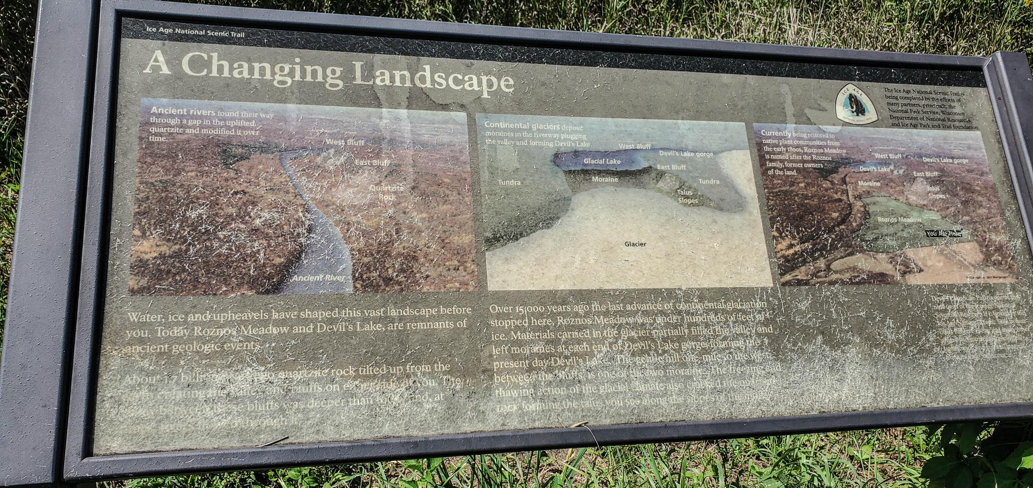 An outdoor interpretive sign titled 'A Changing Landscape' with historical images.