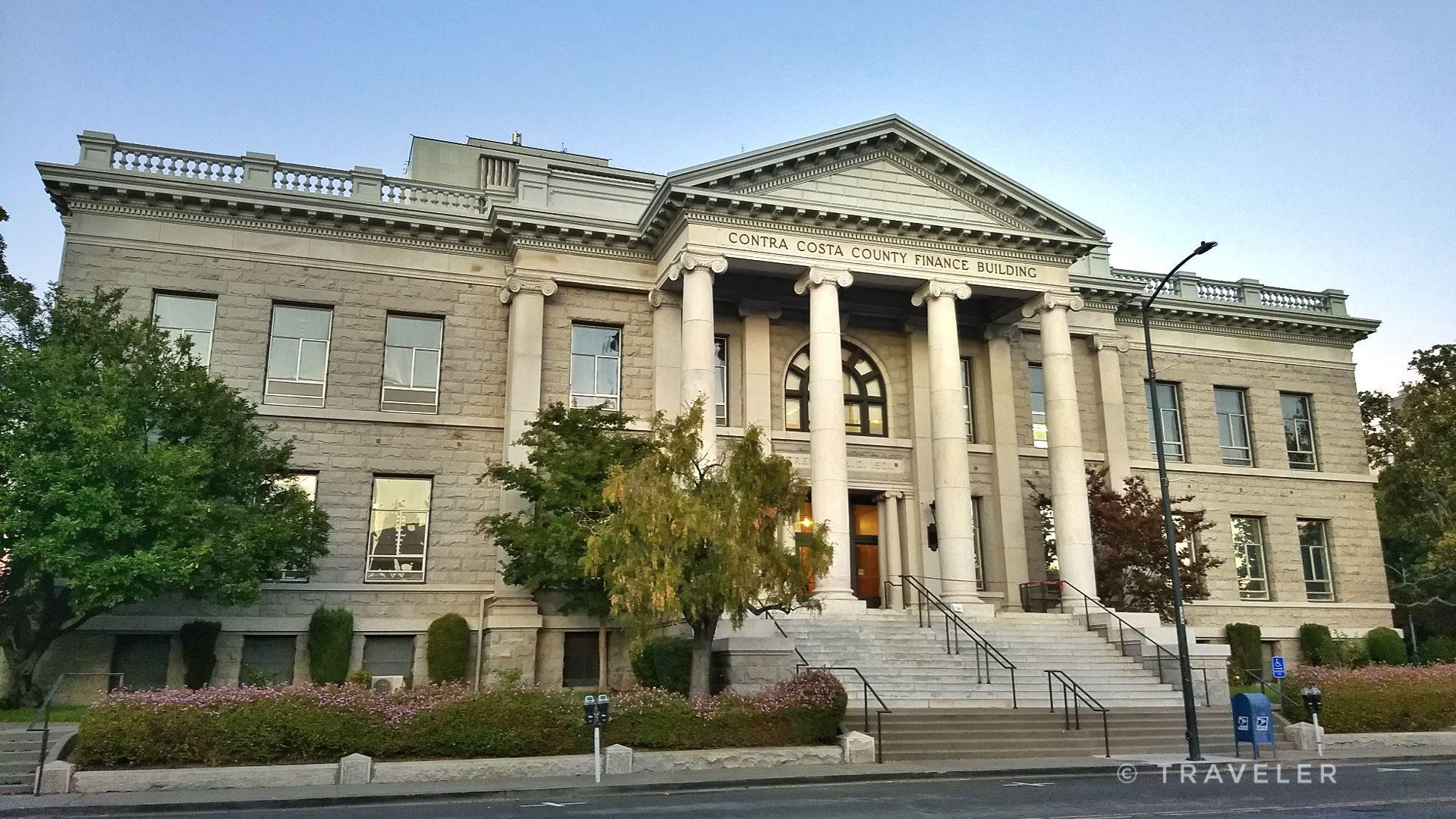 Grand classical building with columns and steps under a clear sky.