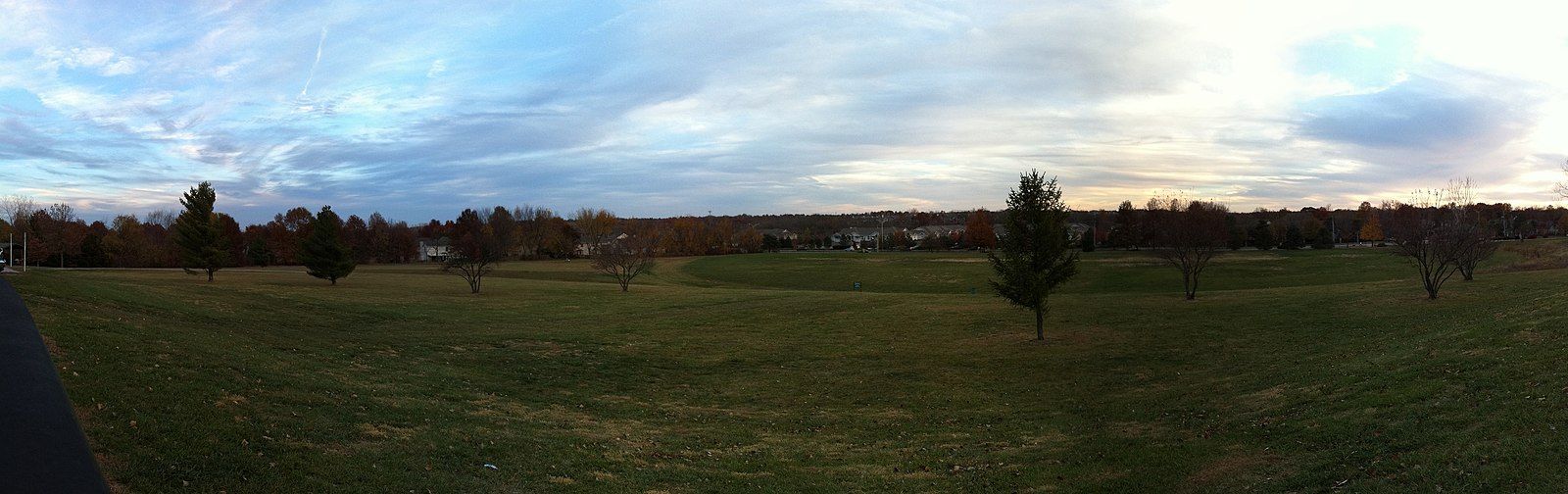Panoramic view of a wide green field with scattered trees under a cloudy sky. - Indian Creek, 133rd St & Eastbrooke Trail Loop