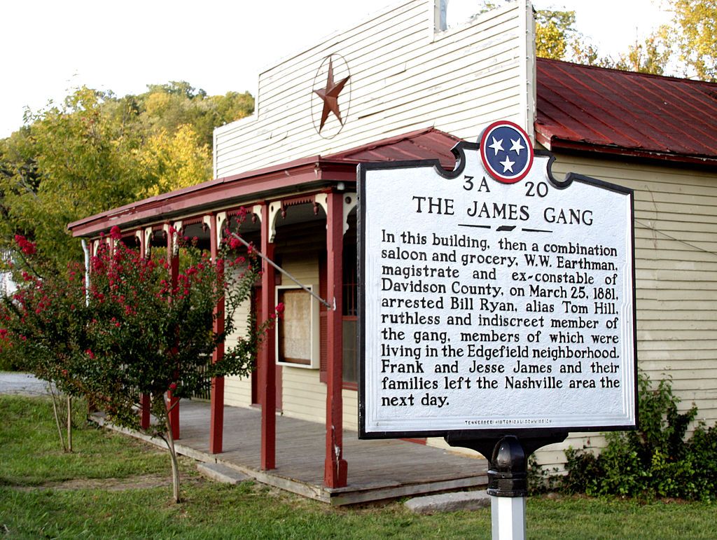 An old white building with a red roof and a historical marker in front. - Whites Creek Historic District loop from Whites Creek