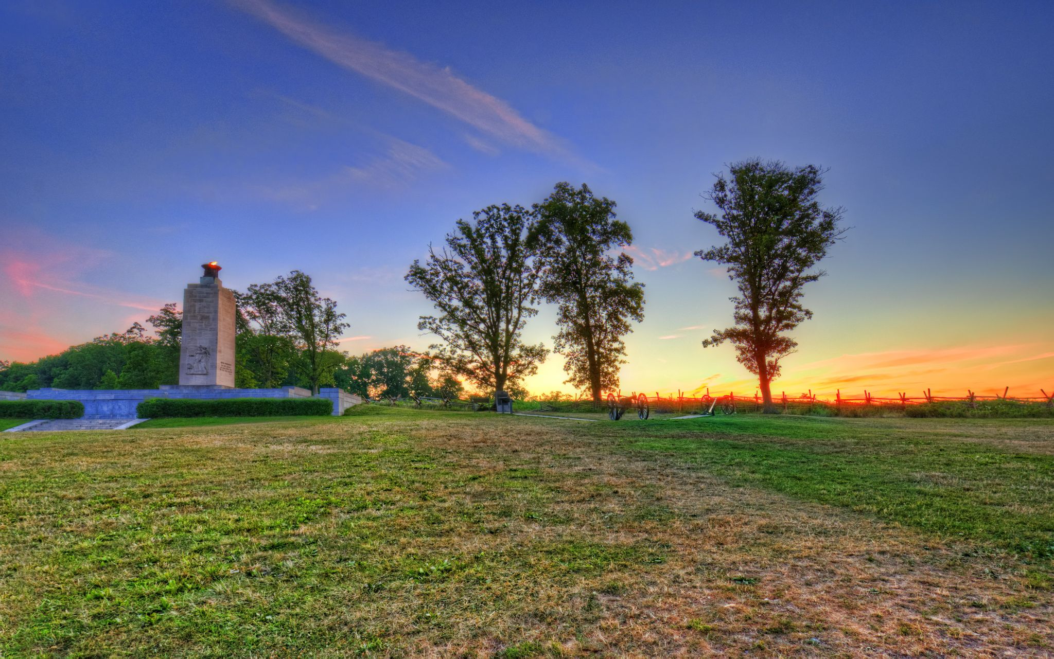Stone monument and trees in a field at sunset with colorful sky. - The apple orchards & York Springs loop from Gettysburg