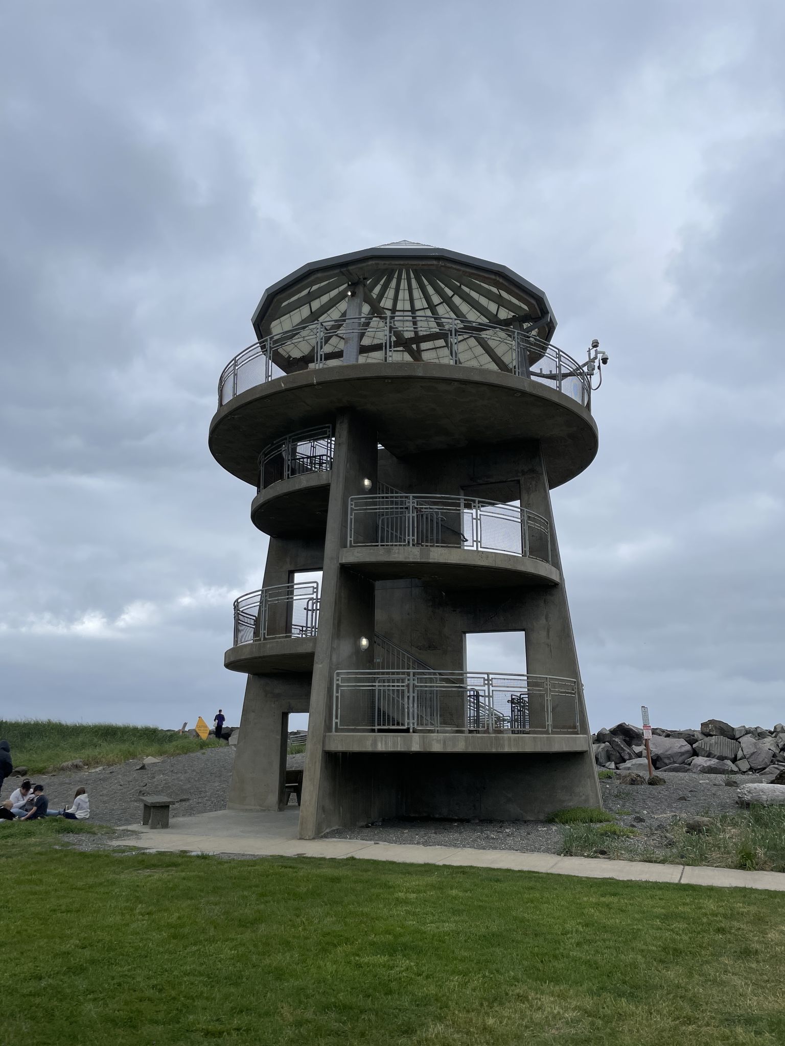 Concrete observation tower under a cloudy sky, people nearby. - Westport Light Loop – Westport Viewing Tower loop from Westport