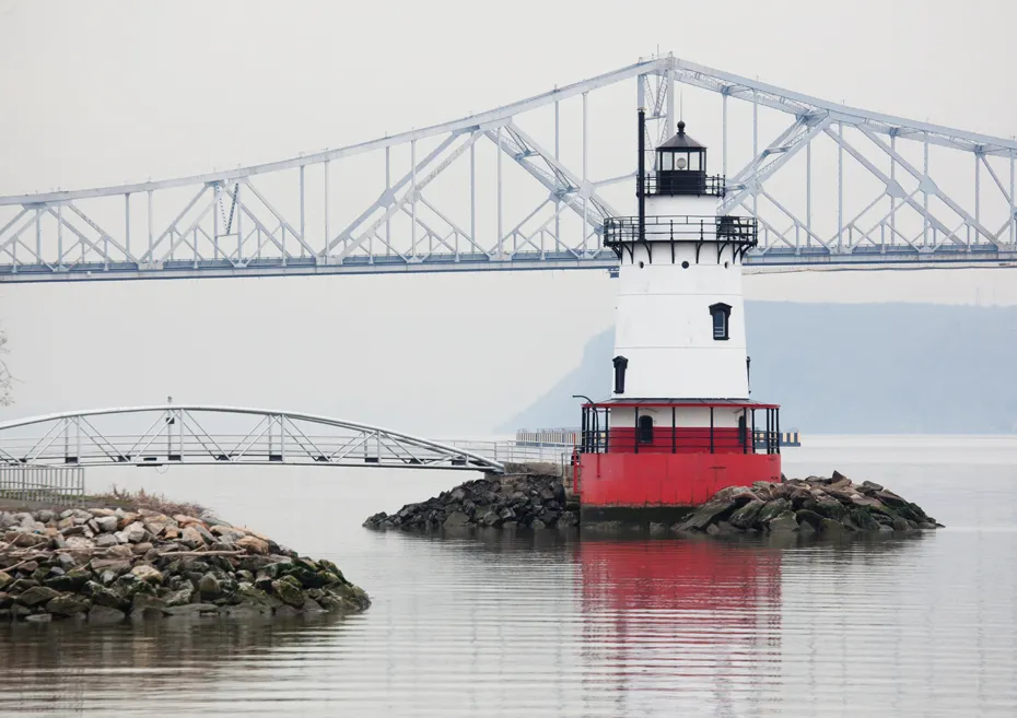 Red and white lighthouse in water with a large bridge behind it. - Tarrytown Riverwalk – Tarrytown Light loop from Village of Tarrytown