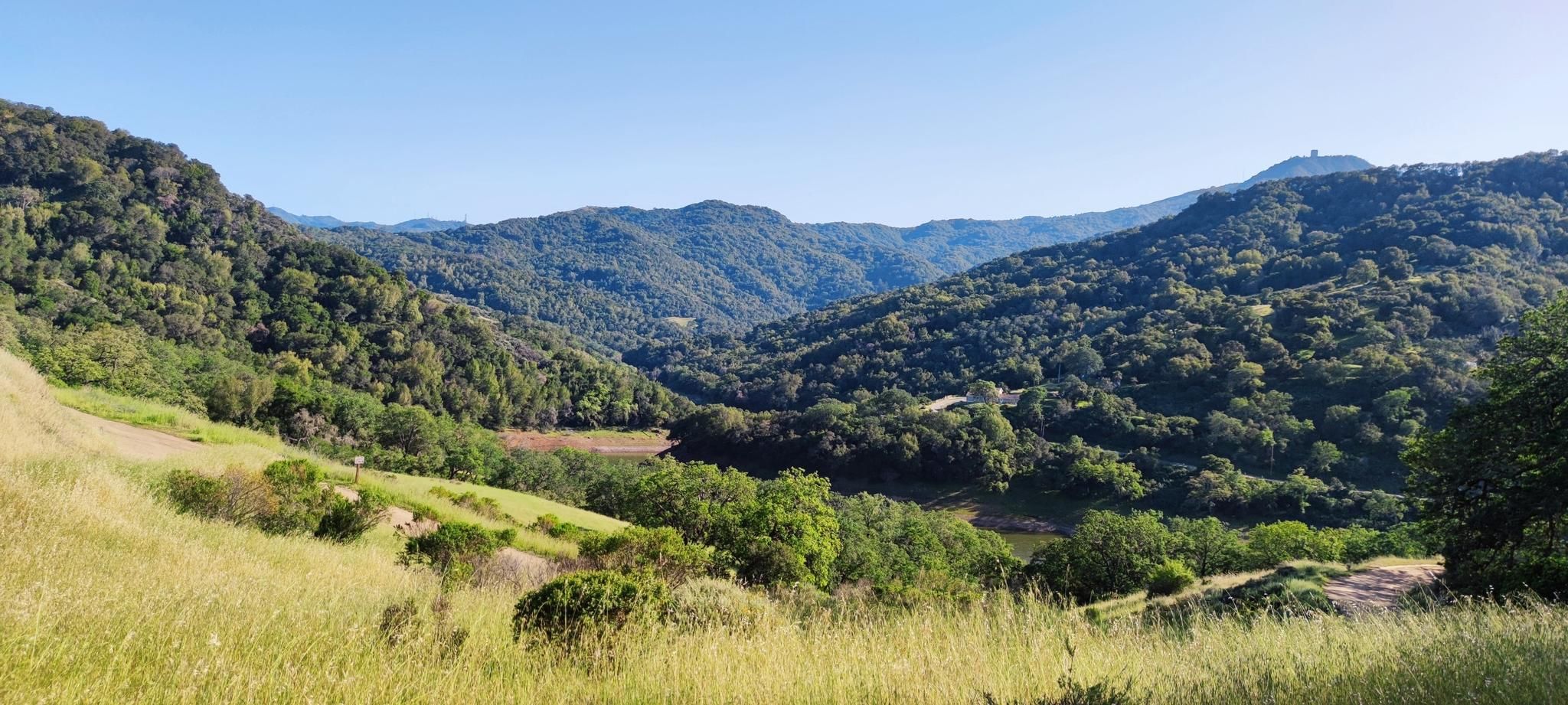 Panoramic view of green valleys and forested hills under a clear blue sky. - Guadalupe and Mine Hill Trail Loop