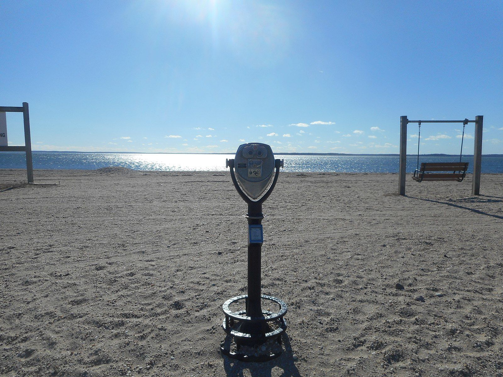 A coin-operated telescope on a sunny beach overlooks a sparkling ocean. - Orient Point Ferry to Orient Beach